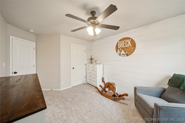 2704 W Imperial St, Broken Arrow, OK 74011 - living area featuring carpet floors, a ceiling fan, baseboards, and wooden walls