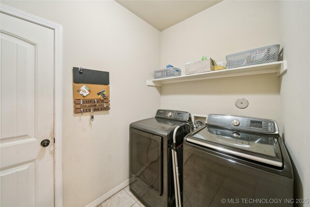 2704 W Imperial St, Broken Arrow, OK 74011 - laundry area with washer and clothes dryer, light tile patterned floors, and baseboards