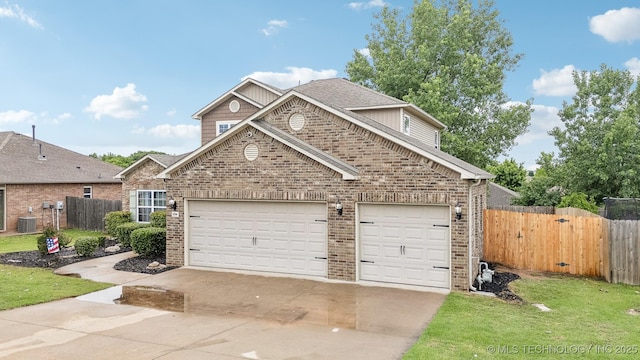 2704 W Imperial St, Broken Arrow, OK 74011 - traditional home featuring driveway, brick siding, central air condition unit, a garage, and a shingled roof