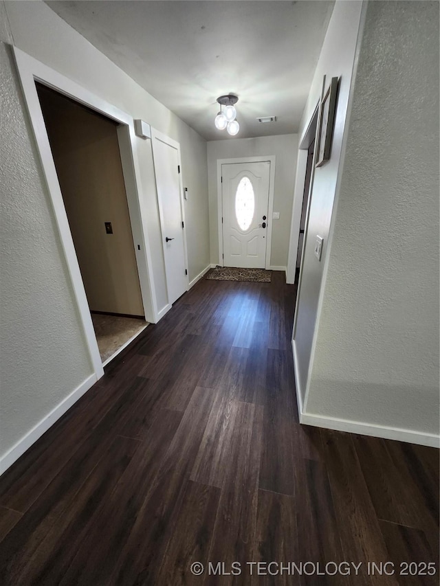 2230 Robin Ln, Muskogee, OK 74403 - foyer featuring dark wood finished floors, baseboards, and a textured wall
