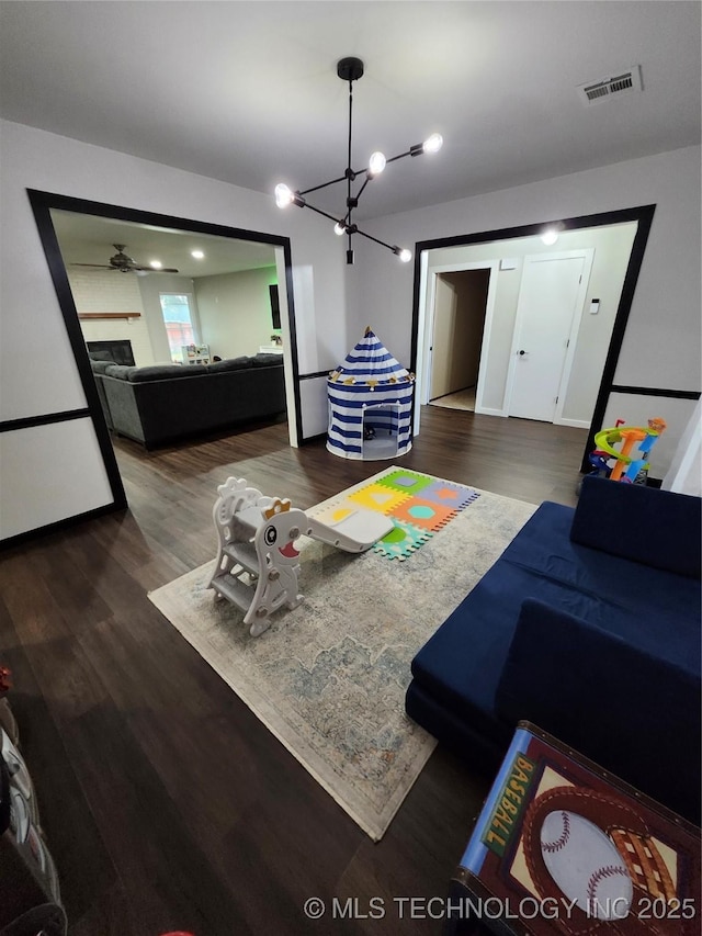 2230 Robin Ln, Muskogee, OK 74403 - living room with wood finished floors, a chandelier, and a fireplace