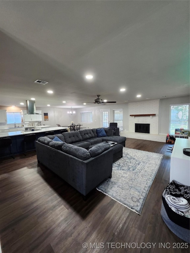 2230 Robin Ln, Muskogee, OK 74403 - living room featuring dark wood-style flooring, recessed lighting, a fireplace, and ceiling fan