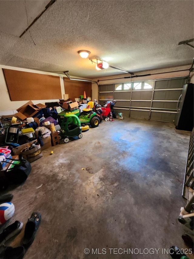 2230 Robin Ln, Muskogee, OK 74403 - garage featuring freestanding refrigerator and a garage door opener