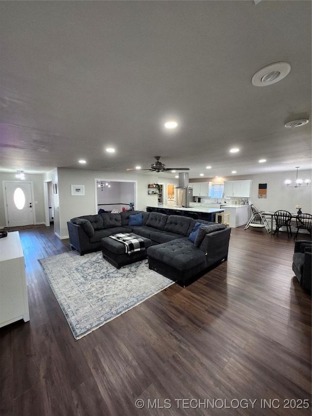 2230 Robin Ln, Muskogee, OK 74403 - living room with dark wood-style flooring, recessed lighting, ceiling fan, baseboards, and a chandelier