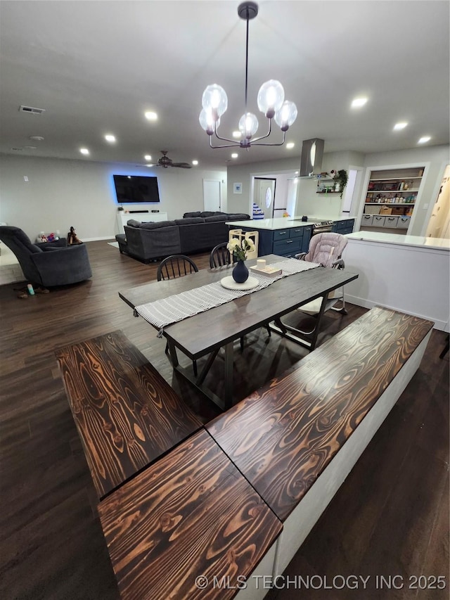 2230 Robin Ln, Muskogee, OK 74403 - dining area featuring dark wood finished floors, recessed lighting, ceiling fan, and a chandelier