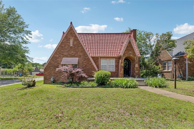1648 S Evanston Ave, Tulsa, OK 74104 - tudor home with a tiled roof, a front lawn, and brick siding