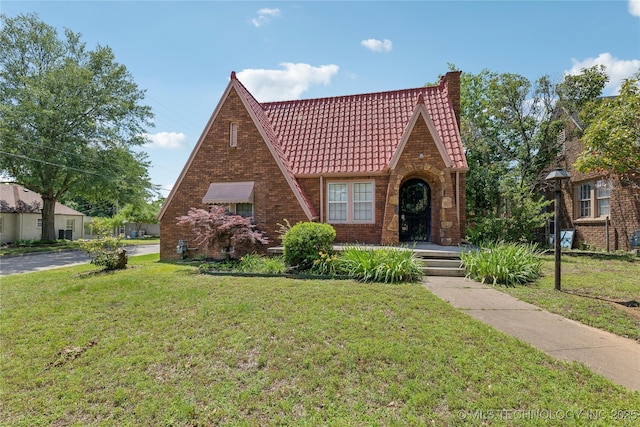 1648 S Evanston Ave, Tulsa, OK 74104 - tudor house featuring a tiled roof, a front lawn, a chimney, and brick siding