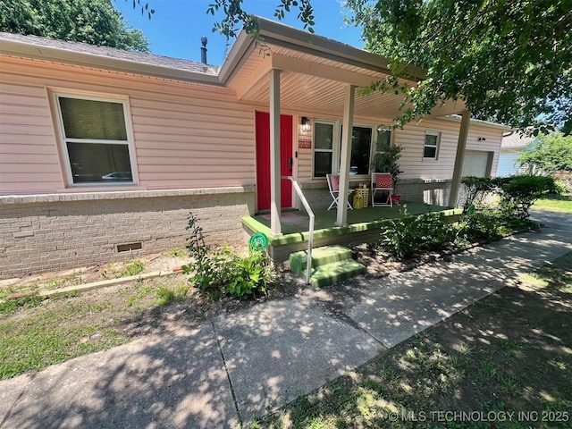 1610 S Ash Ave, Broken Arrow, OK 74012 - view of front facade featuring covered porch, brick siding, and a garage
