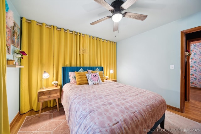1610 S Ash Ave, Broken Arrow, OK 74012 - bedroom featuring wood finished floors, baseboards, and a ceiling fan