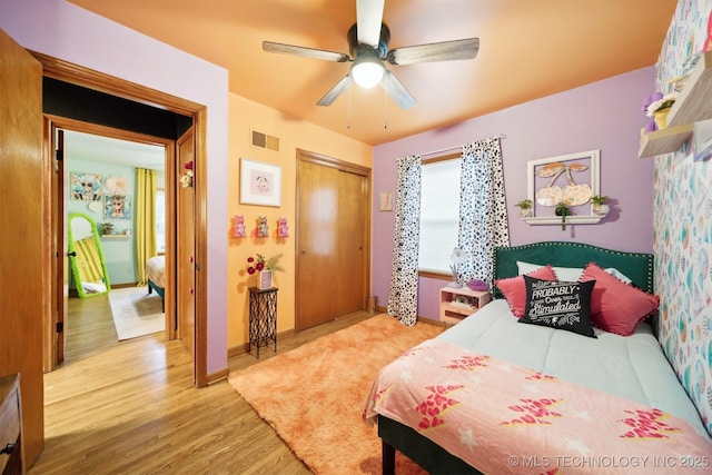 1610 S Ash Ave, Broken Arrow, OK 74012 - bedroom with wood finished floors, a closet, ceiling fan, and baseboards