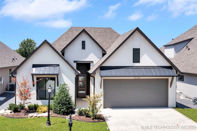 1230 N 71st Pl, Broken Arrow, OK 74014 - view of front of property featuring a standing seam roof, stucco siding, an attached garage, and metal roof