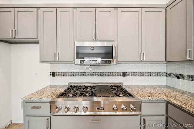 10901 E 95th St N, Owasso, OK 74055 - kitchen with stainless steel appliances, gray cabinetry, and tasteful backsplash