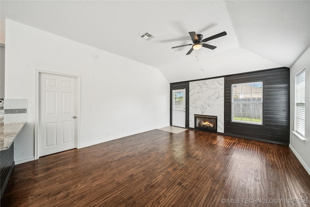 10901 E 95th St N, Owasso, OK 74055 - unfurnished living room featuring lofted ceiling, a ceiling fan, wood finished floors, a fireplace, and baseboards