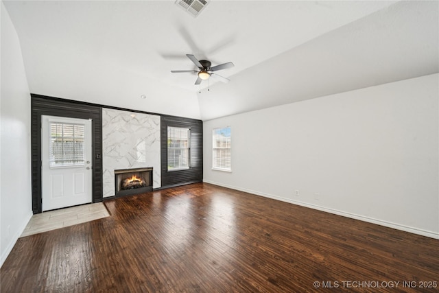 10901 E 95th St N, Owasso, OK 74055 - unfurnished living room featuring a ceiling fan, baseboards, wood finished floors, a fireplace, and vaulted ceiling