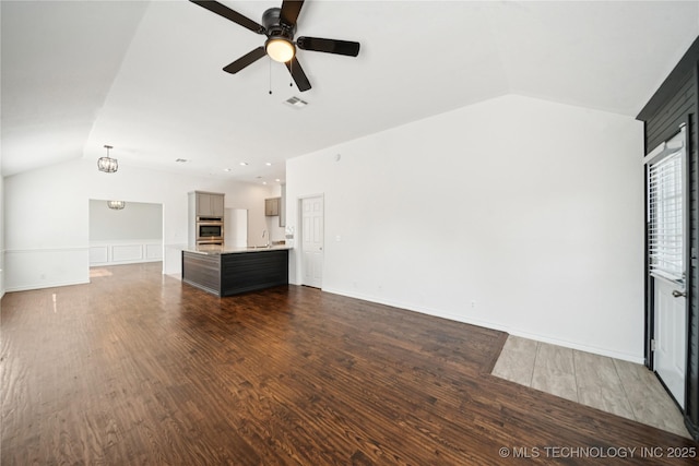 10901 E 95th St N, Owasso, OK 74055 - unfurnished living room featuring lofted ceiling, a sink, dark wood-style flooring, a ceiling fan, and baseboards