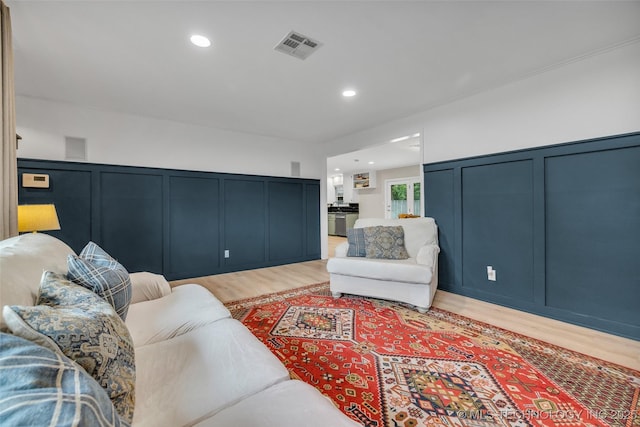 4023 E 36th St S, Tulsa, OK 74135 - living area featuring a decorative wall, light wood-style floors, recessed lighting, and wainscoting