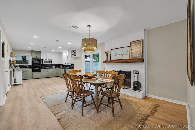 4023 E 36th St S, Tulsa, OK 74135 - dining space with light wood-style floors, recessed lighting, and a brick fireplace