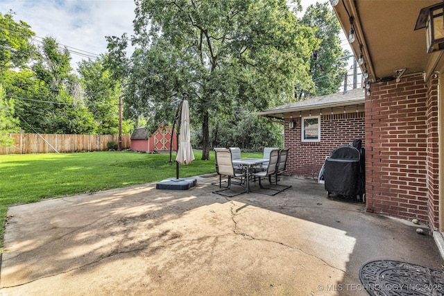 4023 E 36th St S, Tulsa, OK 74135 - view of patio with grilling area, outdoor dining area, and a storage unit