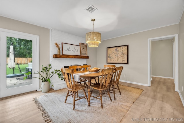 4023 E 36th St S, Tulsa, OK 74135 - dining area featuring wood finished floors, crown molding, and a chandelier