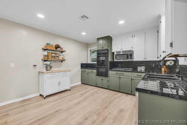 4023 E 36th St S, Tulsa, OK 74135 - kitchen featuring appliances with stainless steel finishes, tasteful backsplash, light wood-style floors, open shelves, and tile counters