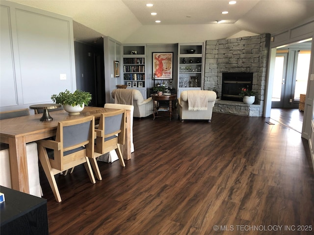 18820 Ridge Rd, Catoosa, OK 74015 - dining space with vaulted ceiling, built in shelves, a stone fireplace, dark wood-style floors, and recessed lighting