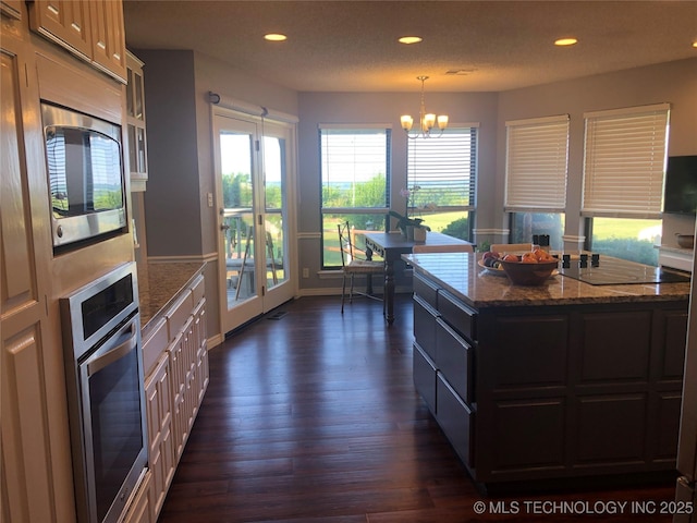 18820 Ridge Rd, Catoosa, OK 74015 - kitchen with stainless steel appliances, dark stone countertops, a chandelier, recessed lighting, and a center island