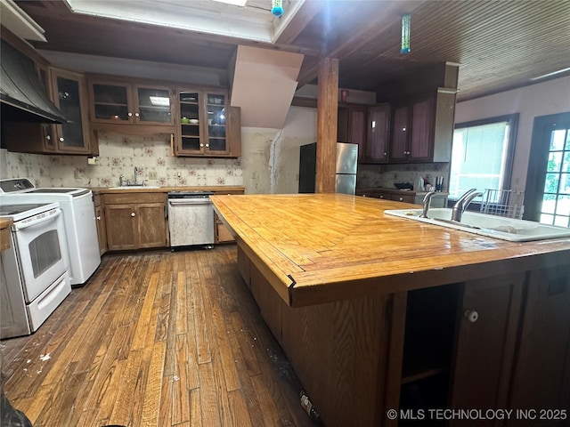 502 S Okmulgee Ave, Okmulgee, OK 74447 - kitchen with butcher block countertops, appliances with stainless steel finishes, dark wood-style floors, and backsplash