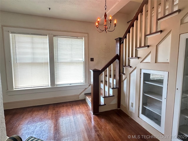 502 S Okmulgee Ave, Okmulgee, OK 74447 - staircase featuring a chandelier, wood finished floors, healthy amount of natural light, and a textured ceiling