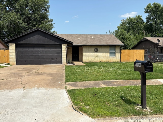 1310 S 38th St, Muskogee, OK 74401 - ranch-style home featuring brick siding, an attached garage, concrete driveway, and roof with shingles