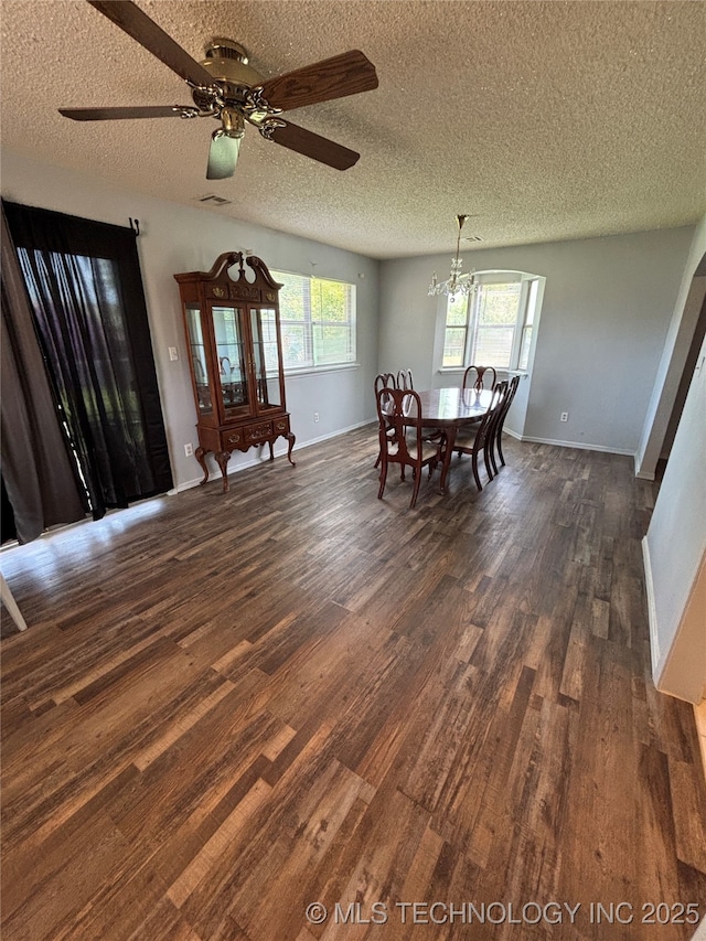 1310 S 38th St, Muskogee, OK 74401 - dining area featuring dark wood finished floors, a textured ceiling, baseboards, ceiling fan, and a chandelier