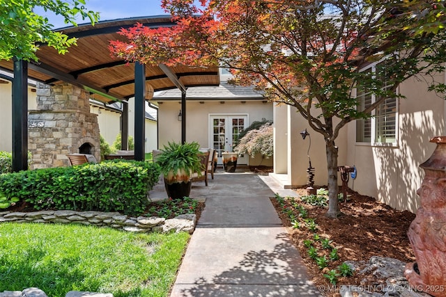 1336 E 35th Pl, Tulsa, OK 74105 - property entrance with a fireplace, stucco siding, and french doors