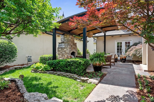 1336 E 35th Pl, Tulsa, OK 74105 - exterior space featuring an outdoor stone fireplace, stucco siding, a patio, and stone siding