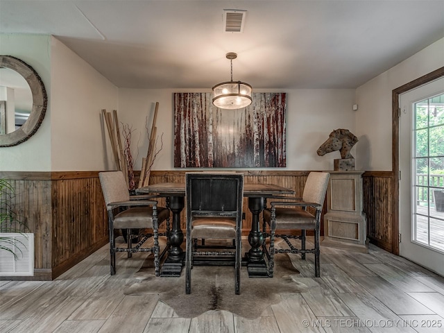 32188 E 738th Rd, Wagoner, OK 74467 - dining area with a wainscoted wall, wood finished floors, and wood walls