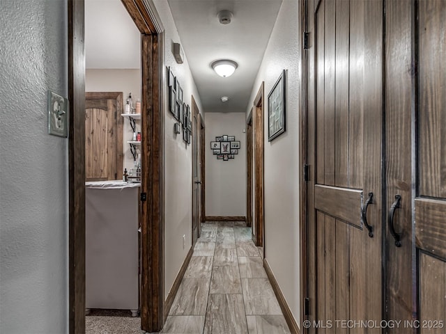 32188 E 738th Rd, Wagoner, OK 74467 - hallway featuring a textured wall and baseboards