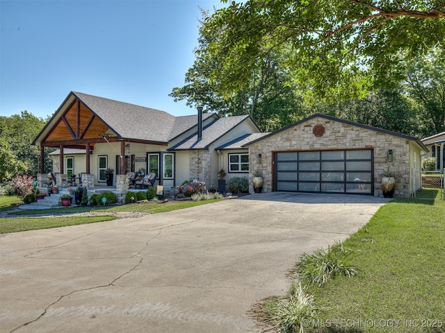32188 E 738th Rd, Wagoner, OK 74467 - view of front of home featuring a porch, stone siding, roof with shingles, and concrete driveway