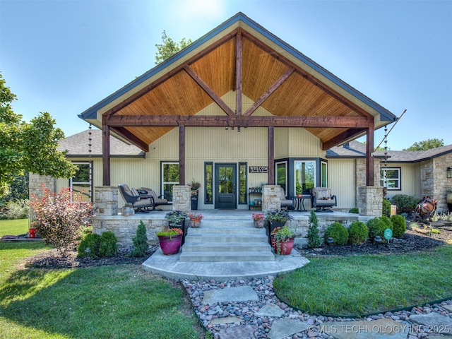 32188 E 738th Rd, Wagoner, OK 74467 - back of property with stone siding, a lawn, and roof with shingles