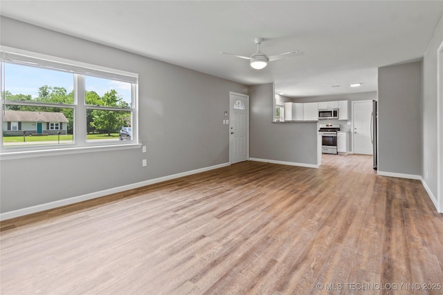 245 E 148th St S, Glenpool, OK 74033 - unfurnished living room with baseboards, light wood-style floors, and ceiling fan