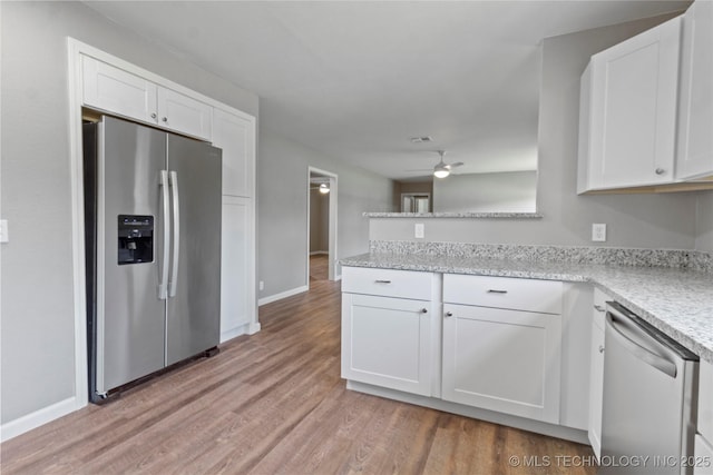 245 E 148th St S, Glenpool, OK 74033 - kitchen with appliances with stainless steel finishes, light wood-type flooring, white cabinetry, and baseboards