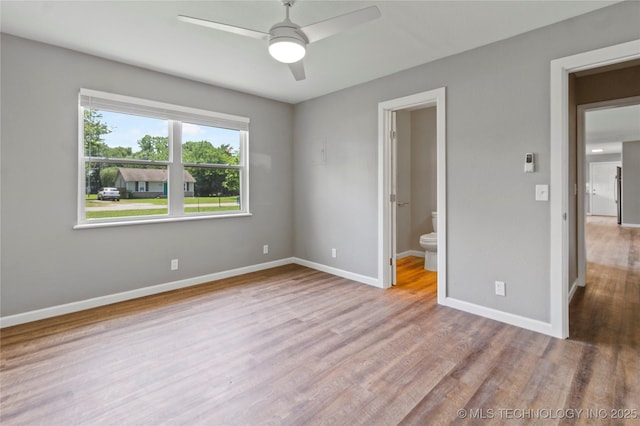 245 E 148th St S, Glenpool, OK 74033 - unfurnished bedroom with wood finished floors, baseboards, ensuite bath, and ceiling fan