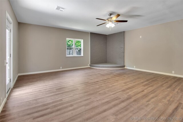 245 E 148th St S, Glenpool, OK 74033 - empty room featuring ceiling fan, wood finished floors, and baseboards