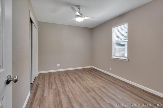 245 E 148th St S, Glenpool, OK 74033 - unfurnished bedroom featuring wood finished floors, a closet, baseboards, and ceiling fan