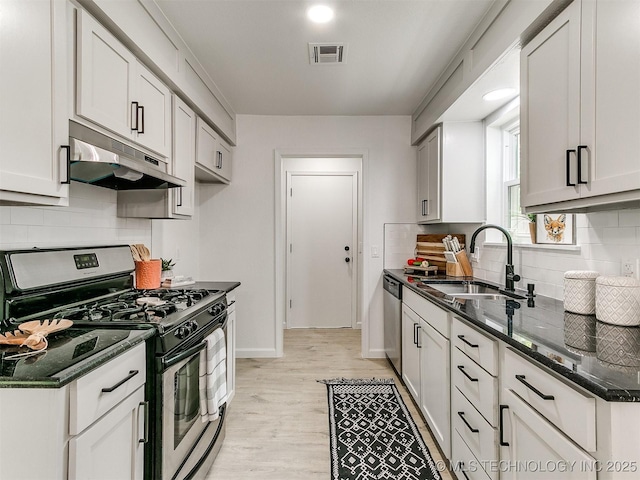 316 E Austin St, Broken Arrow, OK 74011 - kitchen featuring appliances with stainless steel finishes, under cabinet range hood, a sink, and backsplash