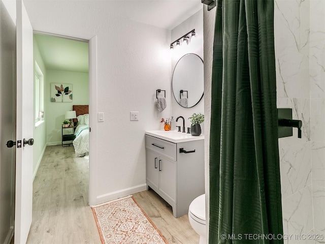 316 E Austin St, Broken Arrow, OK 74011 - ensuite bathroom with wood finished floors, vanity, toilet, baseboards, and a shower with curtain
