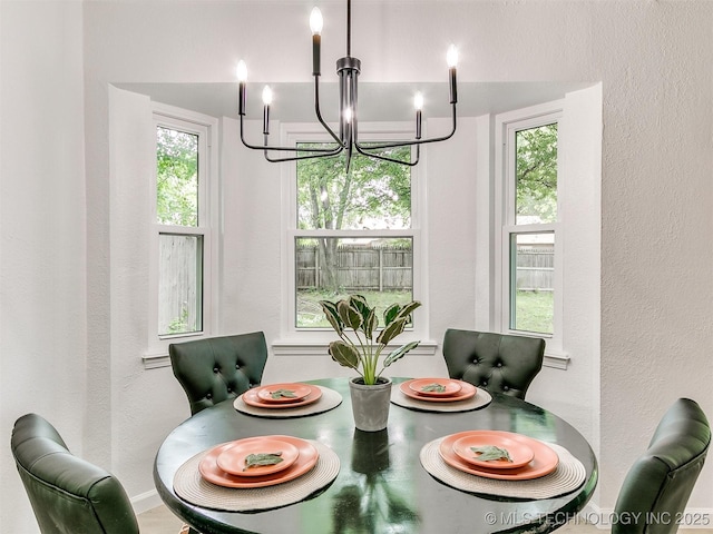 316 E Austin St, Broken Arrow, OK 74011 - dining space with a chandelier and a textured wall