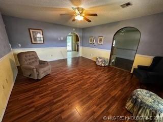 1408 11th NW, Ardmore, OK 73401 - living area featuring arched walkways, ceiling fan, and wood finished floors