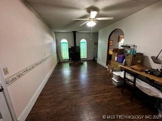 1408 11th NW, Ardmore, OK 73401 - hallway featuring arched walkways, baseboards, wood finished floors, and a textured ceiling