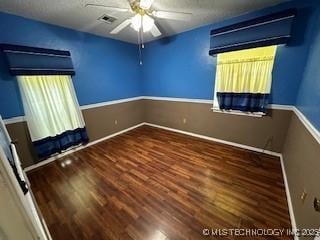 1408 11th NW, Ardmore, OK 73401 - unfurnished room featuring a ceiling fan, wood finished floors, and baseboards