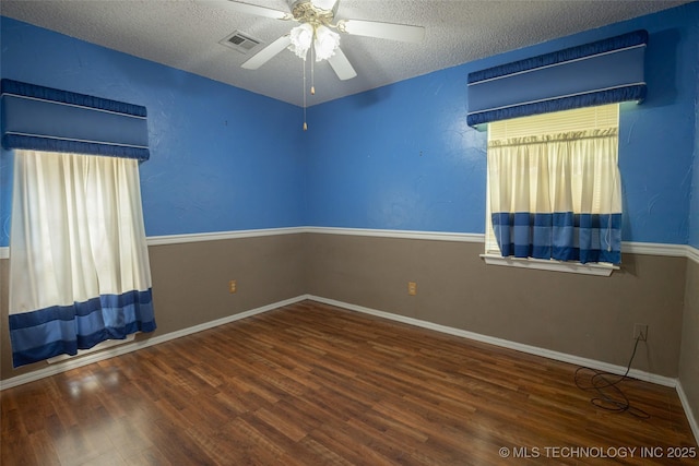 1408 11th NW, Ardmore, OK 73401 - unfurnished room with wood finished floors, a ceiling fan, and a textured ceiling