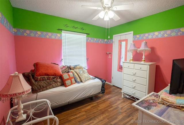 1408 11th NW, Ardmore, OK 73401 - bedroom featuring a textured ceiling, wood finished floors, and ceiling fan