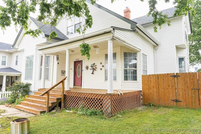 210 S Water St, Sapulpa, OK 74066 - view of front of home with covered porch, a chimney, and a shingled roof